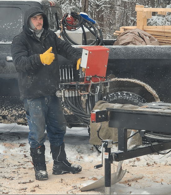 Ryan Thiebault gives "thumbs up" at the controls of their TimberKing.